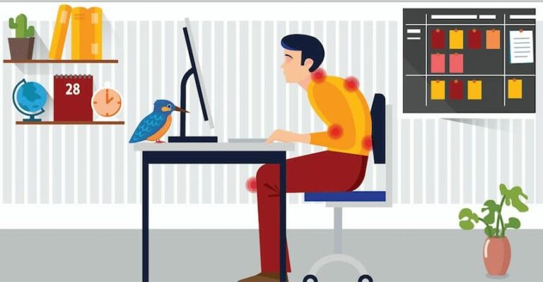 A man sits at a desk working on a computer, with a bird nearby and a calendar and plant in the background.